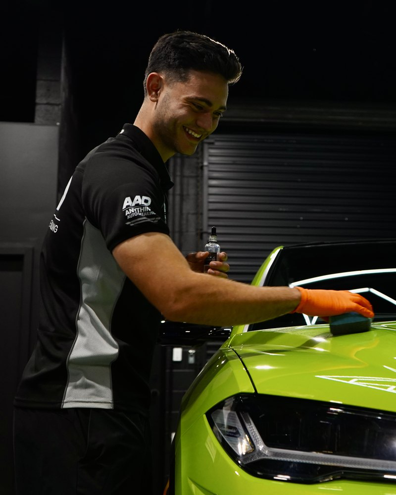 Bailey applying a ceramic coating in the workshop