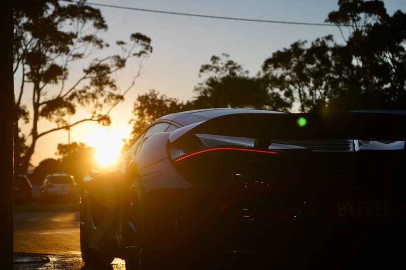 Black McLaren catching the last of the sun after a full detail